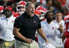 Rutgers' Greg Schiano crashes out on official after costly penalty in tough loss to USC